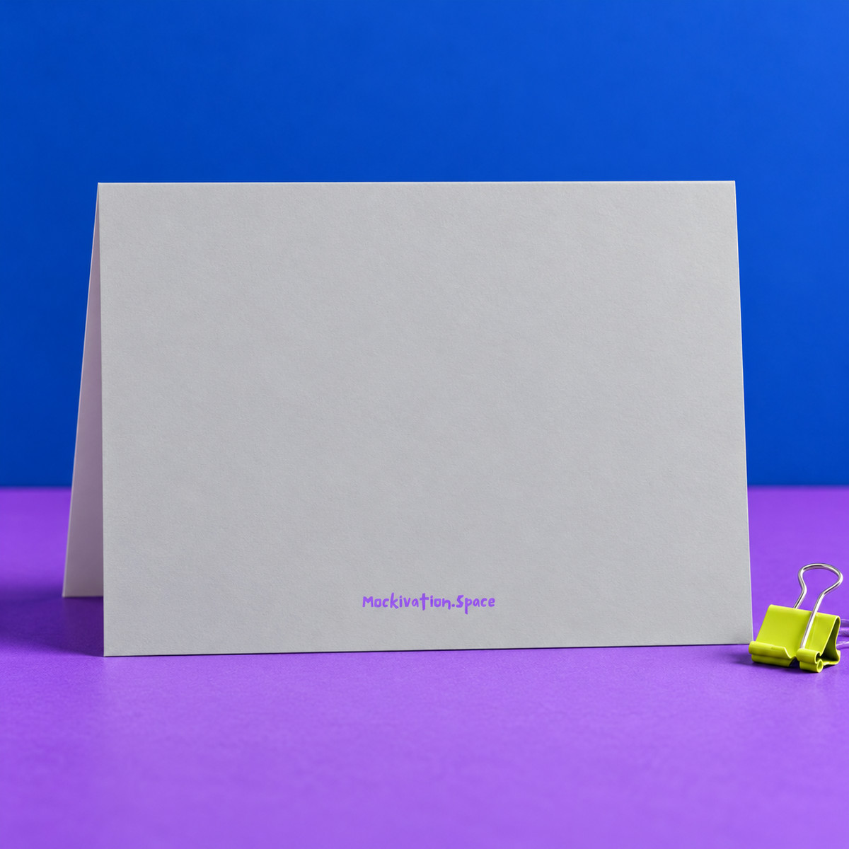 Reverse of the grey Appraisal card with original purple Mockivation.Space branding, shown in the matching cobalt, violet and lemon-lime studio setting
