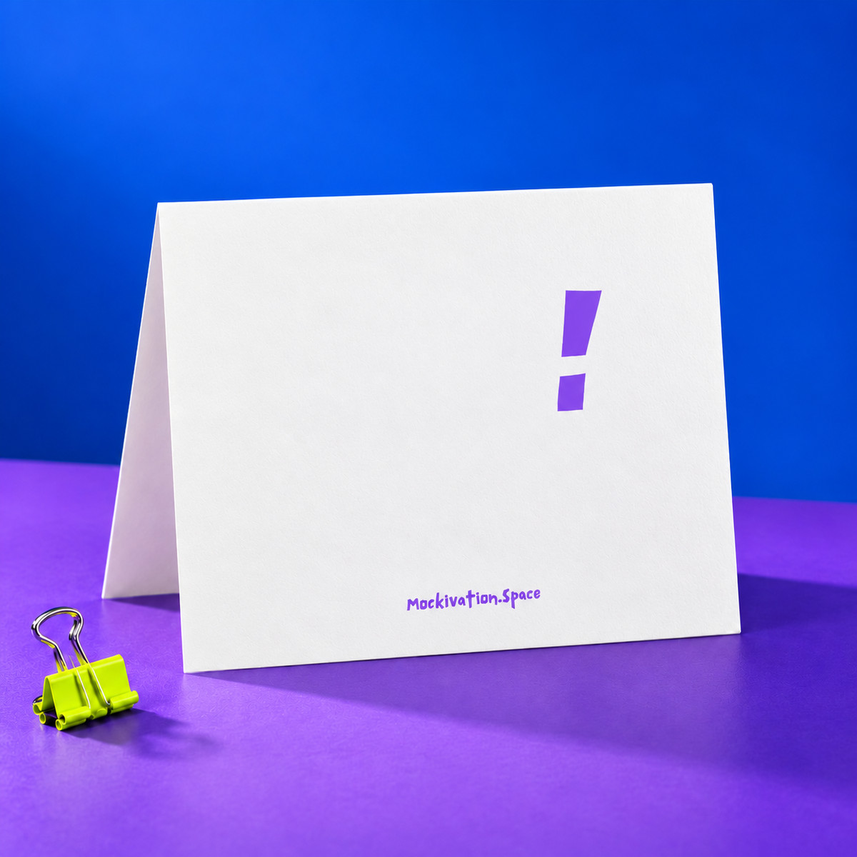 Reverse of the Even Dumbness card with original purple exclamation mark and Mockivation.Space branding, in the matching cobalt, violet and lemon-lime studio setup