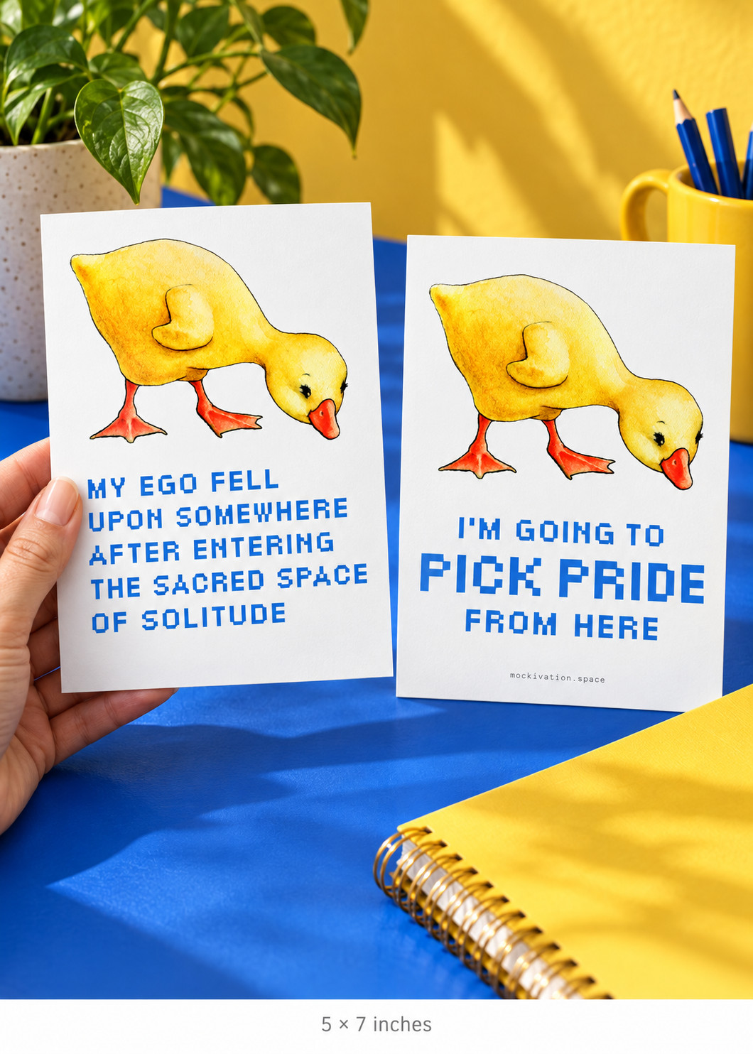 Pick Up Your Pride 5 × 7-inch portrait story card shown in an adult hand beside the reverse, in a yellow and cobalt setting